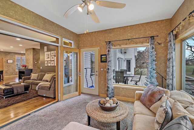 living room featuring carpet floors and ceiling fan