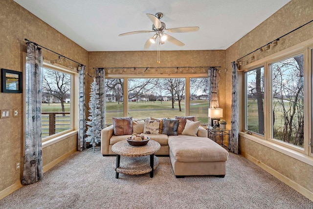 sunroom / solarium with ceiling fan and a healthy amount of sunlight