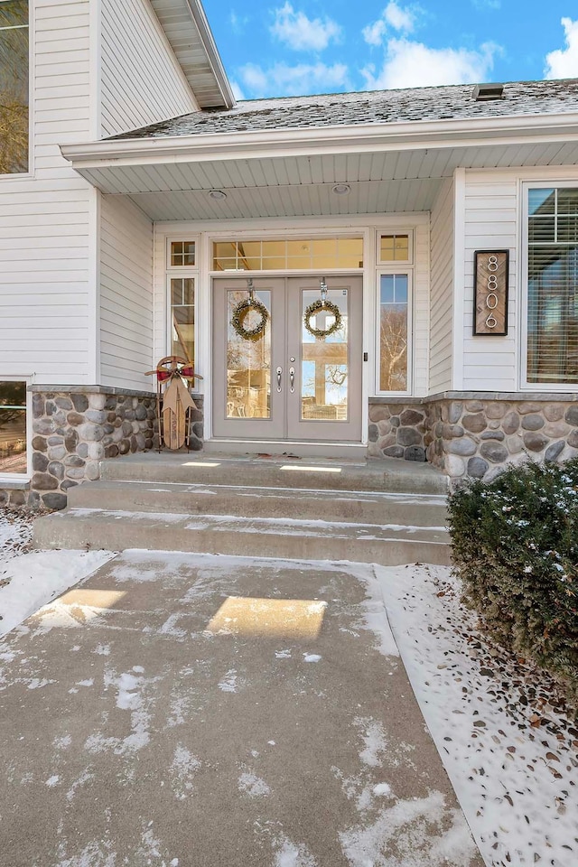 view of exterior entry featuring french doors