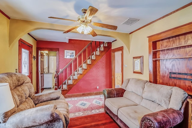 living room with ceiling fan, wood-type flooring, and crown molding