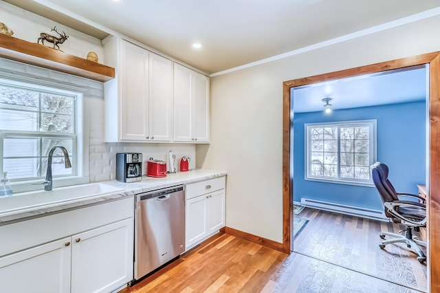 kitchen featuring dishwasher, sink, baseboard heating, white cabinets, and light wood-type flooring