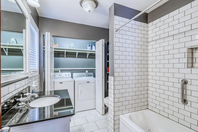 full bathroom with sink, tile patterned flooring, decorative backsplash, toilet, and washing machine and dryer