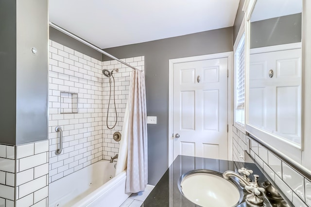 bathroom with tile patterned flooring, shower / bath combo, and sink