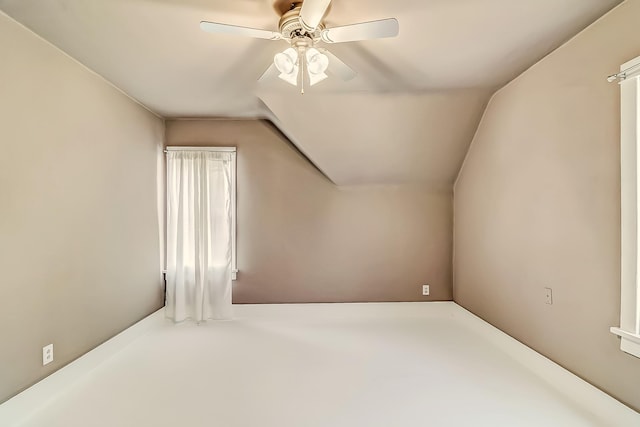 additional living space featuring ceiling fan and lofted ceiling