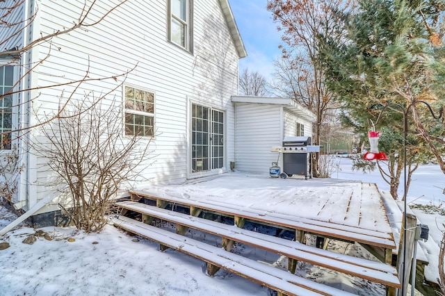 snow covered deck featuring area for grilling