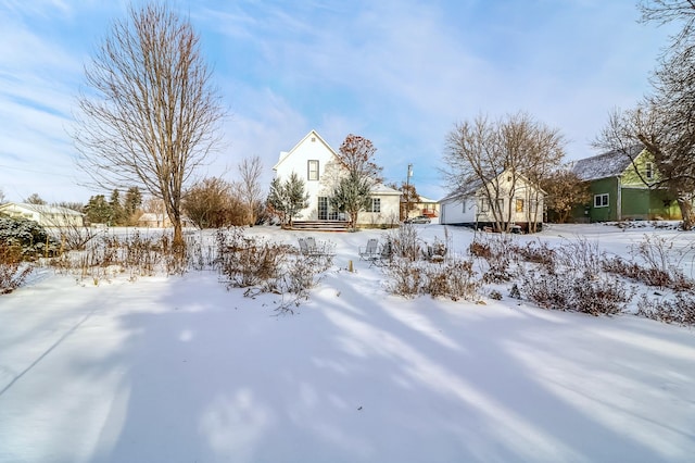 snowy yard featuring a garage