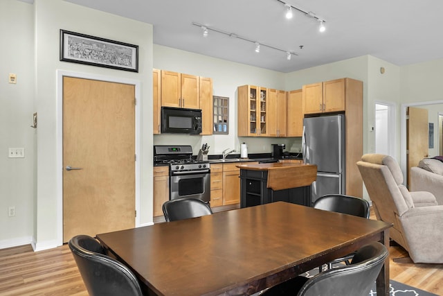 kitchen featuring sink, light wood-type flooring, light brown cabinetry, and appliances with stainless steel finishes