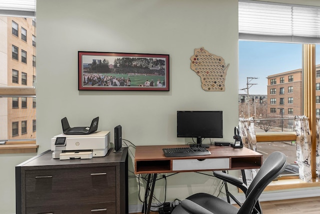 home office with wood-type flooring