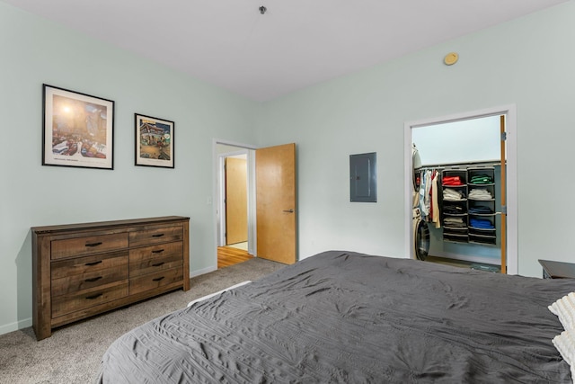 bedroom with carpet flooring, a spacious closet, electric panel, and a closet