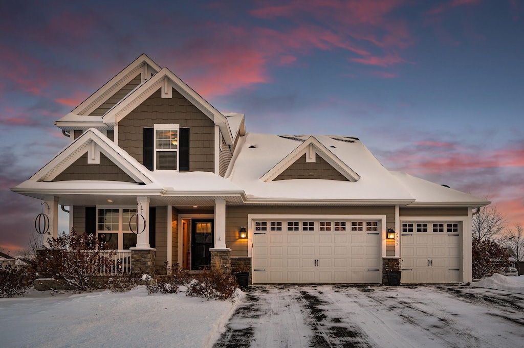 craftsman inspired home featuring a garage and a porch