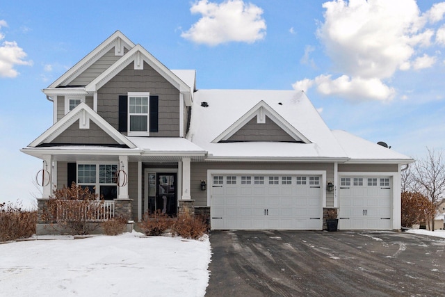 craftsman inspired home featuring a garage and a porch