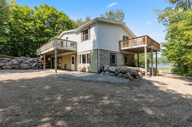 rear view of house with a patio area and a deck