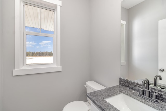 bathroom featuring vanity and toilet