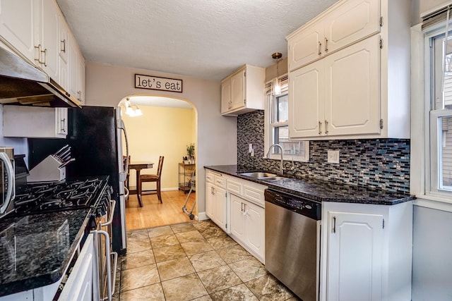 kitchen featuring dishwasher, white cabinets, and a healthy amount of sunlight