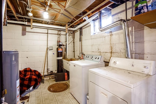 washroom featuring sink, washer and clothes dryer, and water heater