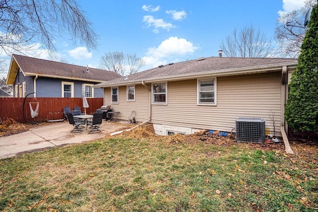 rear view of property featuring a patio area, a yard, and central AC