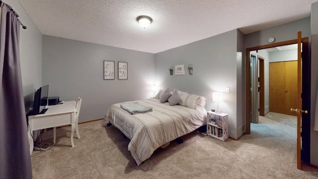 carpeted bedroom featuring a textured ceiling