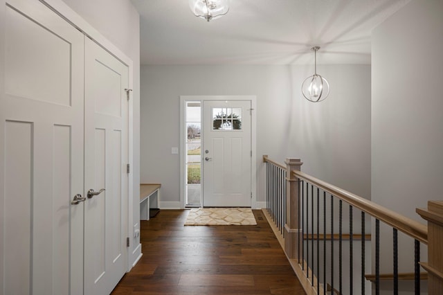 entryway featuring dark hardwood / wood-style flooring and a chandelier