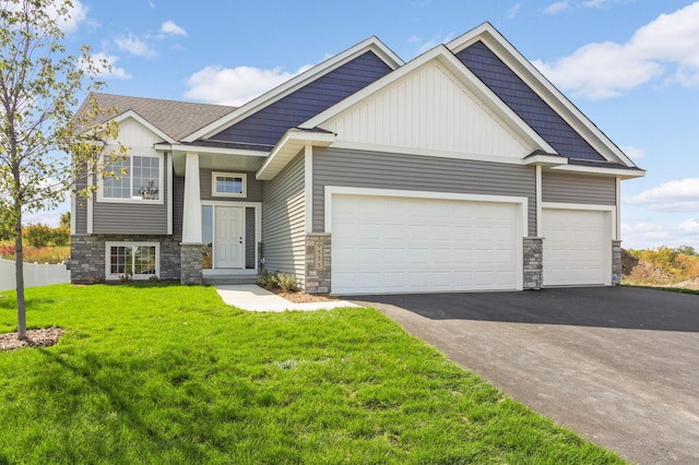 craftsman inspired home with a garage and a front lawn