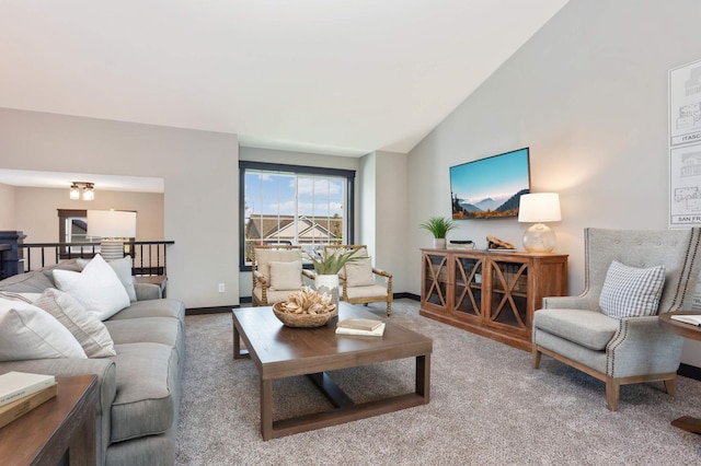 carpeted living room with lofted ceiling