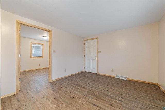 empty room with hardwood / wood-style flooring