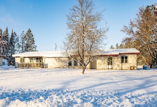 view of snow covered rear of property