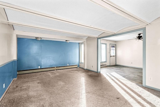 empty room with beamed ceiling, ceiling fan, a textured ceiling, and a baseboard radiator