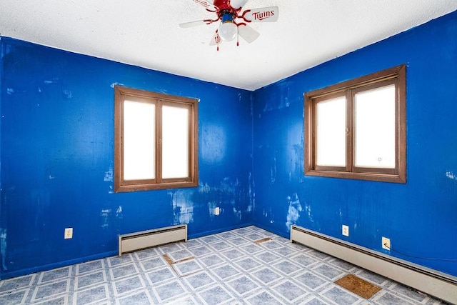 spare room featuring ceiling fan and a baseboard radiator