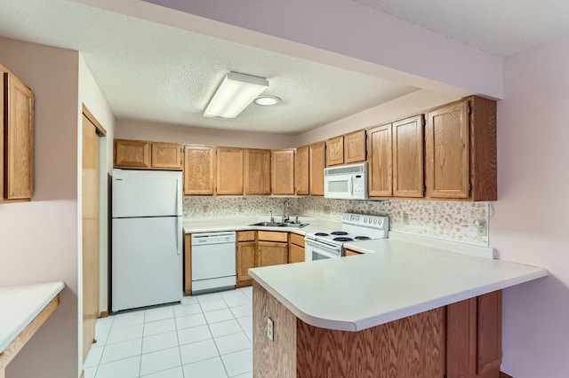 kitchen with kitchen peninsula, tasteful backsplash, white appliances, sink, and light tile patterned floors