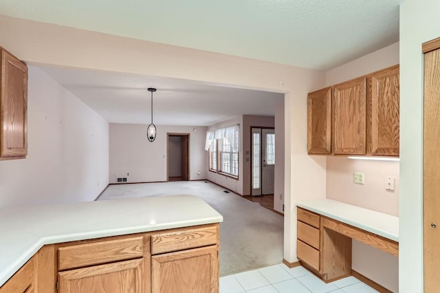 kitchen featuring pendant lighting and light colored carpet