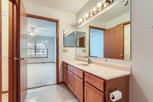 bathroom featuring concrete flooring, a textured ceiling, vanity, and ceiling fan