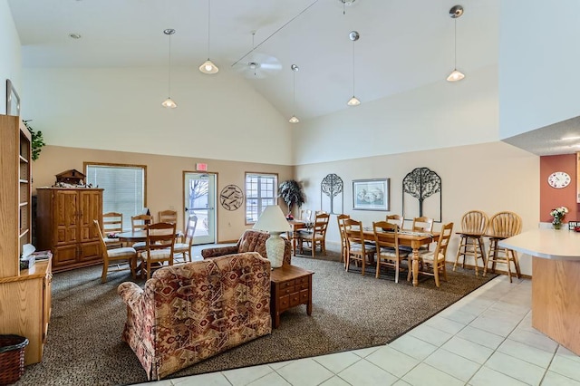 living room with ceiling fan, light colored carpet, and high vaulted ceiling