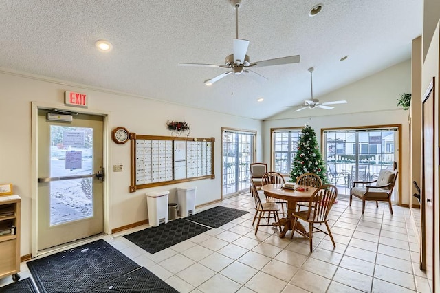 tiled dining space featuring a textured ceiling, ceiling fan, mail boxes, and lofted ceiling