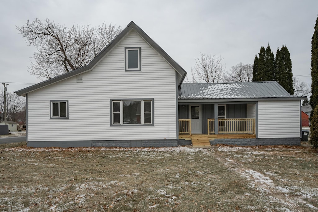 rear view of house featuring covered porch