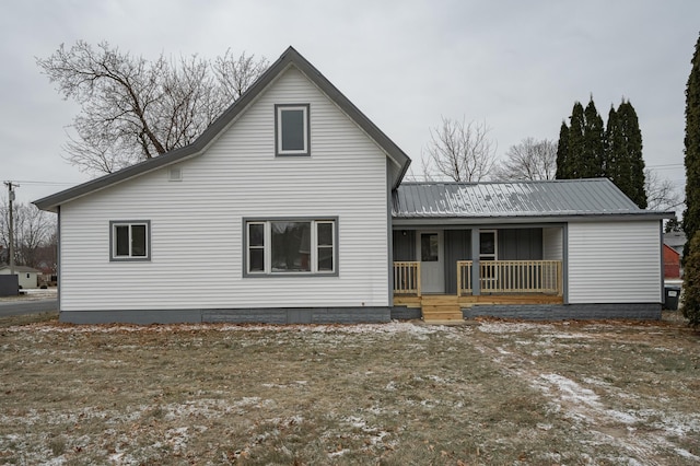 rear view of house featuring covered porch