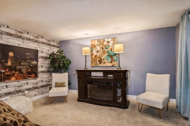 sitting room featuring light carpet and wood walls