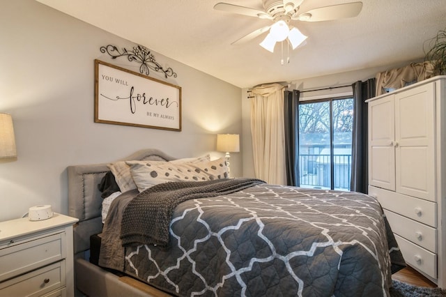 bedroom with access to exterior, ceiling fan, and dark wood-type flooring