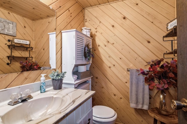 bathroom featuring wooden ceiling and wooden walls