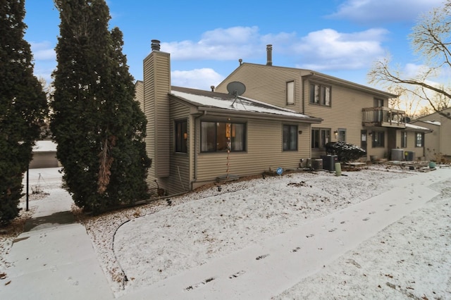 snow covered property with cooling unit