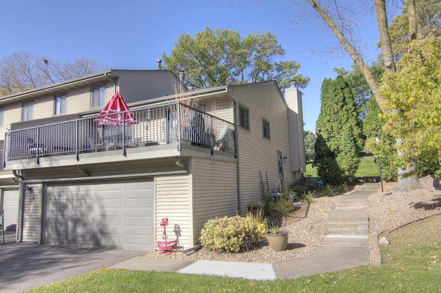 view of front of house featuring a garage and a balcony