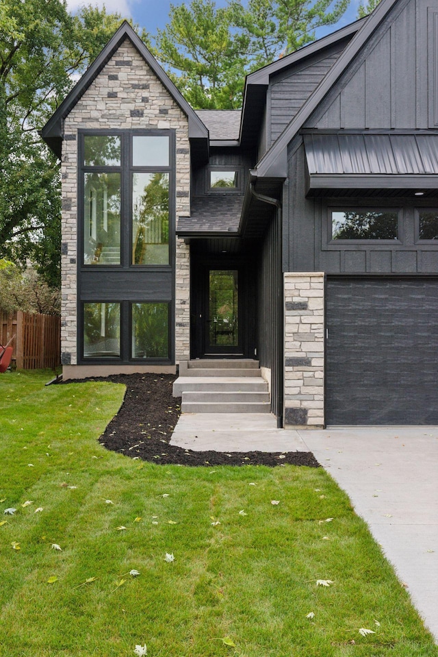 entrance to property featuring a lawn