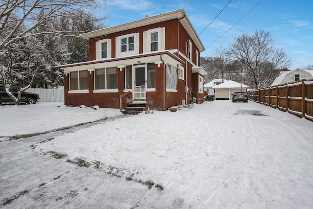 view of front of house featuring a garage and an outdoor structure