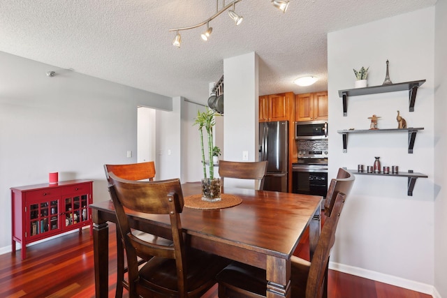 dining space featuring a textured ceiling and dark hardwood / wood-style floors