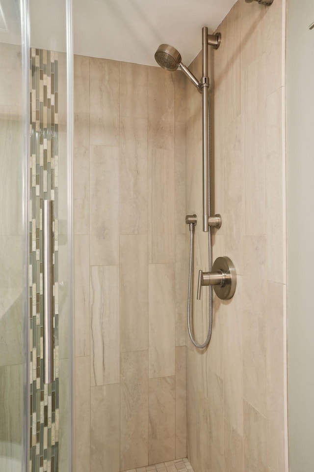 bathroom with a tile shower