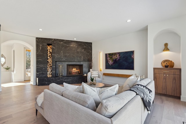 3702 Planting Grn, Stillwater, MN 55082 - living area with arched walkways, recessed lighting, a fireplace, and light wood-type flooring