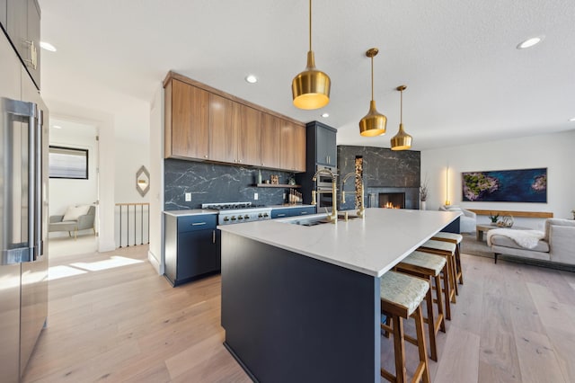 3702 Planting Grn, Stillwater, MN 55082 - kitchen with open floor plan, tasteful backsplash, light wood finished floors, a kitchen breakfast bar, and recessed lighting