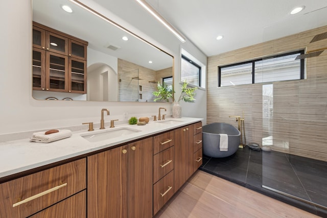 3702 Planting Grn, Stillwater, MN 55082 - bathroom with double vanity, a tile shower, a freestanding tub, and recessed lighting