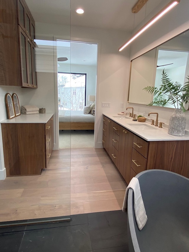 3702 Planting Grn, Stillwater, MN 55082 - ensuite bathroom with double vanity, recessed lighting, and wood finished floors
