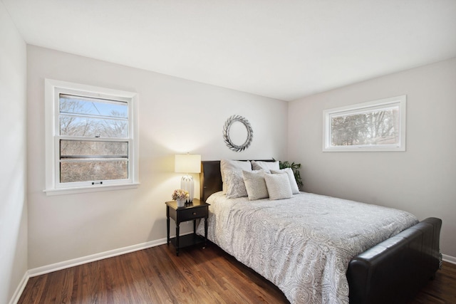 bedroom with dark hardwood / wood-style floors