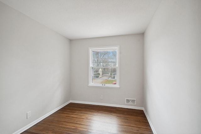 spare room featuring dark wood-type flooring